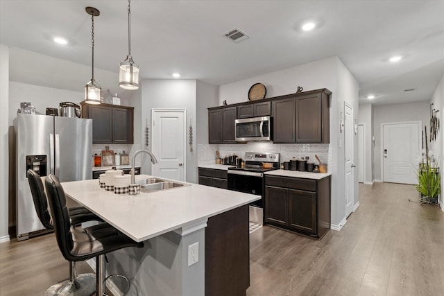 113 Clason Rd, Royse City, TX 75189 - kitchen with appliances with stainless steel finishes, dark brown cabinets, decorative backsplash, a sink, and recessed lighting