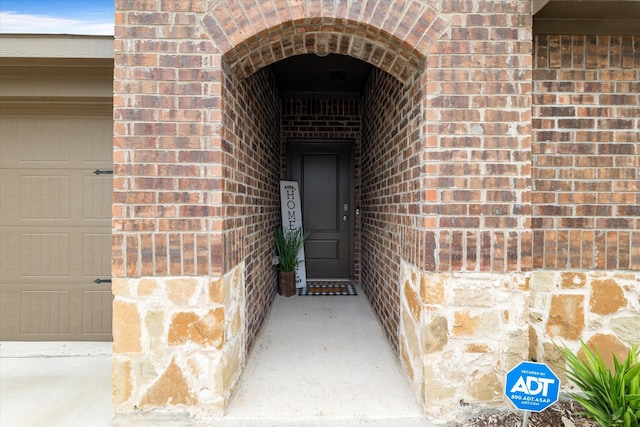doorway to property with brick siding