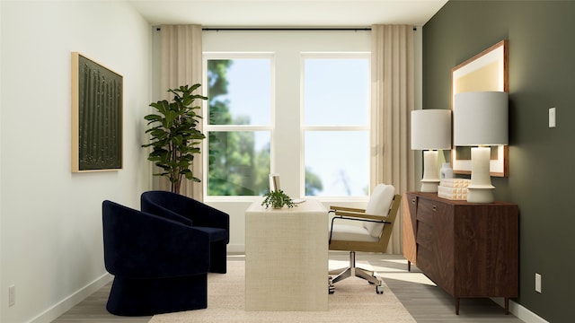 living area featuring wood finished floors, baseboards, and a healthy amount of sunlight