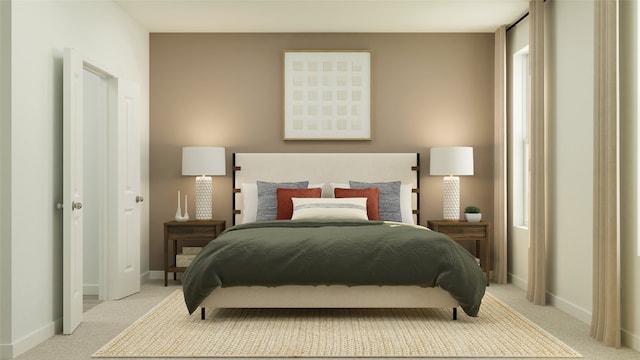 bedroom with light colored carpet and baseboards