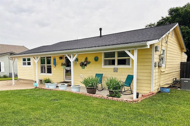 337 S Dobson St, Burleson, TX 76028 - back of house with a shingled roof, a patio, a lawn, and central AC