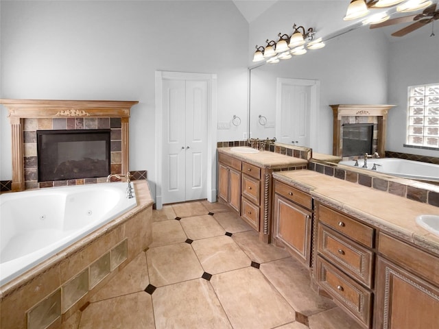 8280 St Johns Dr, Waxahachie, TX 75167 - bathroom featuring vanity, vaulted ceiling, ceiling fan, a whirlpool tub, and a tile fireplace