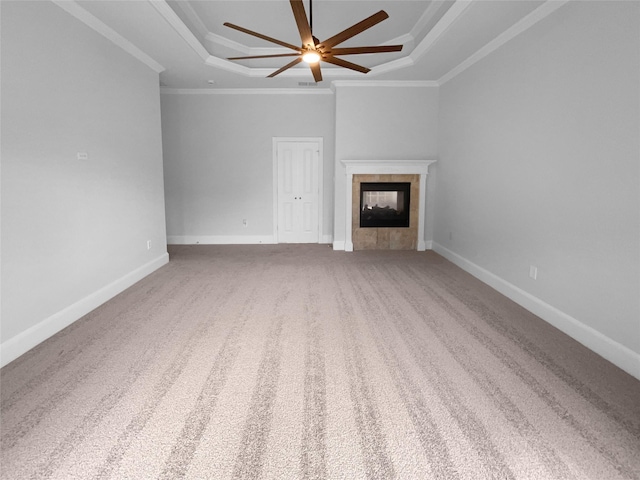 8280 St Johns Dr, Waxahachie, TX 75167 - unfurnished living room featuring carpet flooring, a ceiling fan, a tray ceiling, a tiled fireplace, and crown molding