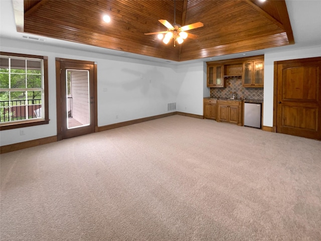 8280 St Johns Dr, Waxahachie, TX 75167 - unfurnished living room featuring baseboards, a raised ceiling, and wood ceiling