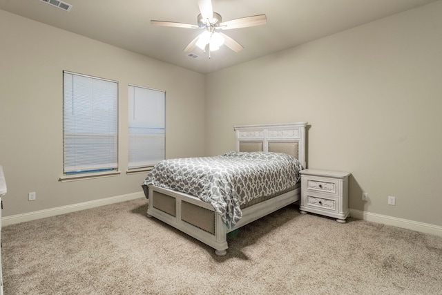 bedroom with ceiling fan, light carpet, baseboards, and visible vents