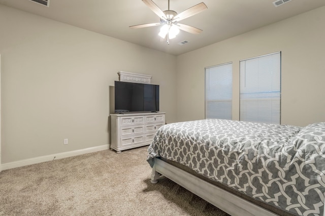 bedroom with light carpet, baseboards, a ceiling fan, and visible vents