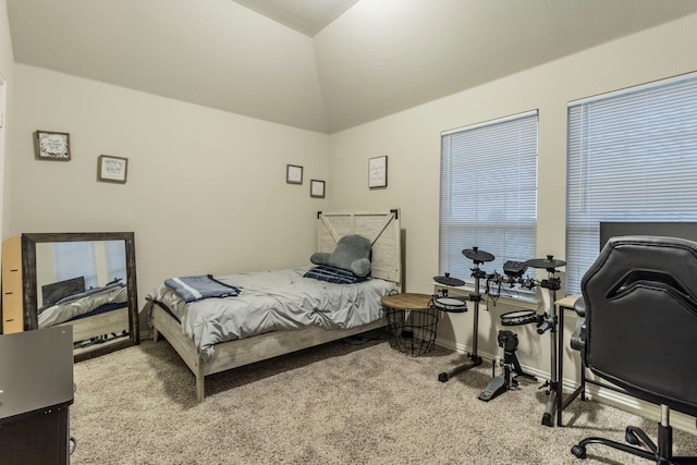 carpeted bedroom with baseboards and lofted ceiling