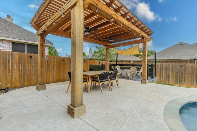 view of patio with a ceiling fan, outdoor dining area, and a fenced backyard