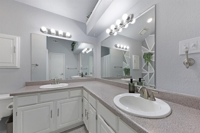 7340 Blackthorn Dr, Fort Worth, TX 76137 - bathroom with toilet, double vanity, a shower with curtain, and a textured wall