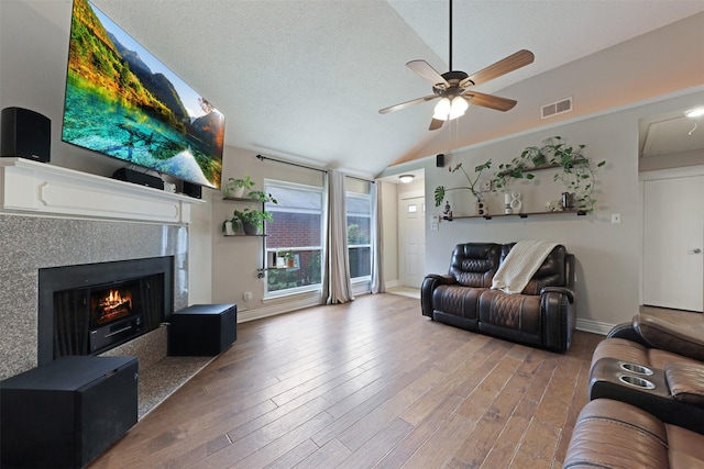 7340 Blackthorn Dr, Fort Worth, TX 76137 - living room with vaulted ceiling, a ceiling fan, wood finished floors, a fireplace, and baseboards