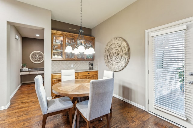 dining area with dark wood-type flooring, baseboards, and a healthy amount of sunlight