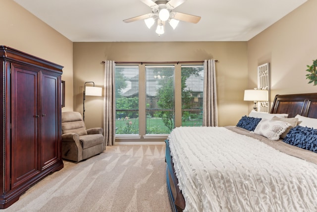 bedroom with a ceiling fan and light carpet
