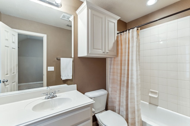 full bathroom featuring toilet, vanity, visible vents, and shower / bath combo