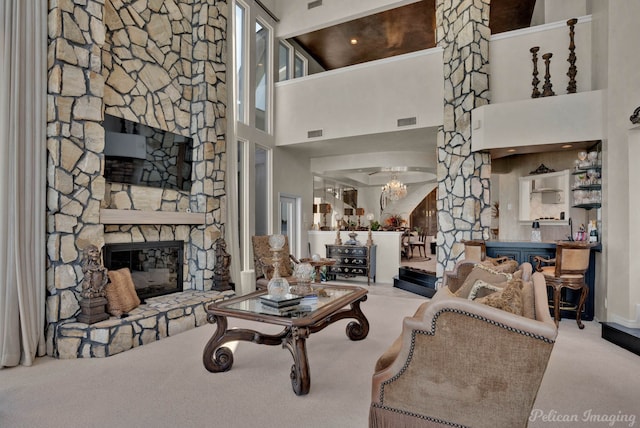 5705 Shoreline Dr, Shreveport, LA 71119 - carpeted living area featuring a fireplace, visible vents, and a towering ceiling