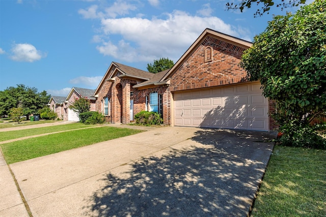 view of front of house featuring a garage, a front lawn, roof with shingles, brick siding, and driveway