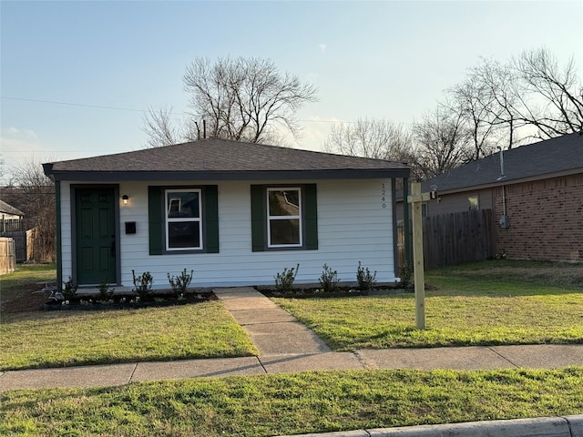bungalow with fence and a front yard