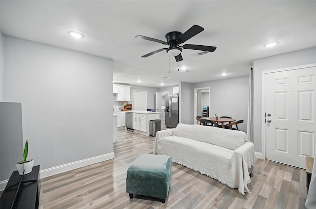 11519 Desdemona Dr, Dallas, TX 75228 - bedroom with stainless steel refrigerator with ice dispenser, light wood finished floors, recessed lighting, and baseboards
