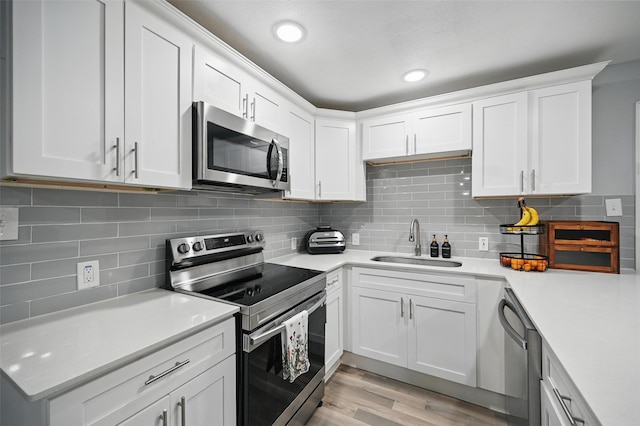 11519 Desdemona Dr, Dallas, TX 75228 - kitchen with stainless steel appliances, a sink, light countertops, tasteful backsplash, and recessed lighting