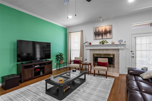 3811 Maywood Dr, Carrollton, TX 75007 - living area featuring a fireplace, ornamental molding, wood finished floors, baseboards, and a ceiling fan