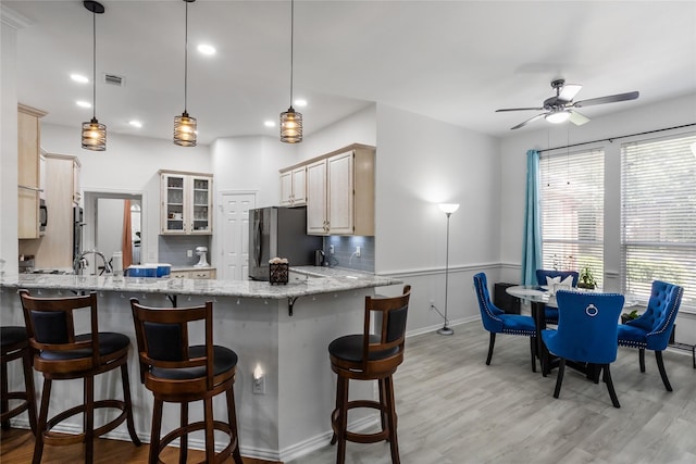 3811 Maywood Dr, Carrollton, TX 75007 - kitchen featuring freestanding refrigerator, a peninsula, light wood-style flooring, a ceiling fan, and recessed lighting