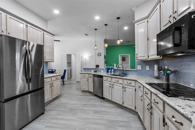 3811 Maywood Dr, Carrollton, TX 75007 - kitchen with black appliances, a sink, a peninsula, backsplash, and hanging light fixtures