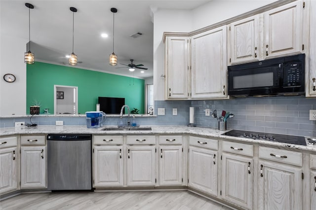 3811 Maywood Dr, Carrollton, TX 75007 - kitchen with black appliances, a sink, tasteful backsplash, pendant lighting, and light stone counters