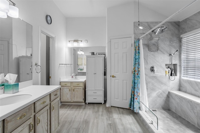3811 Maywood Dr, Carrollton, TX 75007 - bathroom featuring tiled shower, wood finished floors, and two vanities