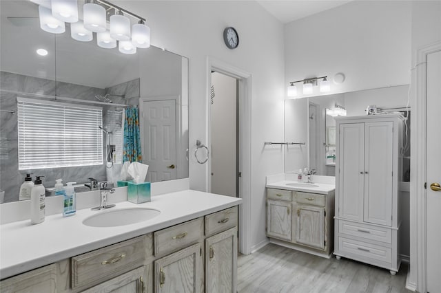 3811 Maywood Dr, Carrollton, TX 75007 - full bath featuring a shower with shower curtain, two vanities, and wood finished floors