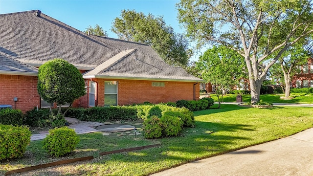 3811 Maywood Dr, Carrollton, TX 75007 - view of side of home featuring brick siding, a yard, and roof with shingles