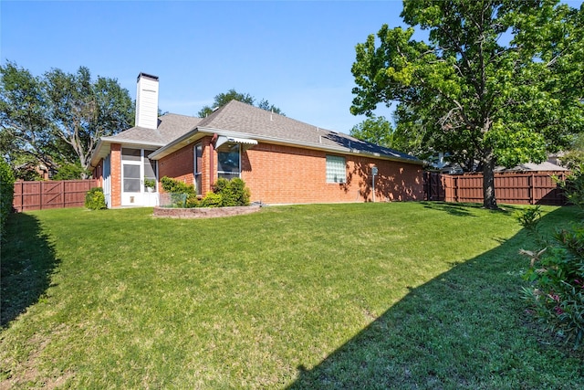 3811 Maywood Dr, Carrollton, TX 75007 - rear view of property with brick siding, a chimney, a shingled roof, and a sunroom