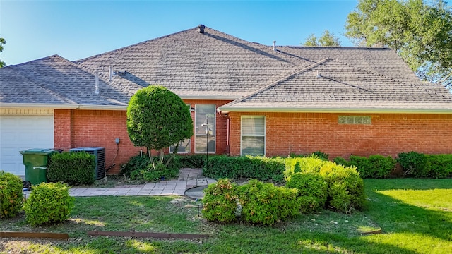 3811 Maywood Dr, Carrollton, TX 75007 - view of front facade featuring brick siding, a front lawn, an attached garage, and a shingled roof