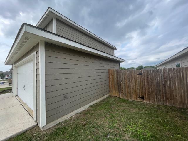 11757 Davalos Ln, San Antonio, TX 78252 - view of side of property with fence and a garage