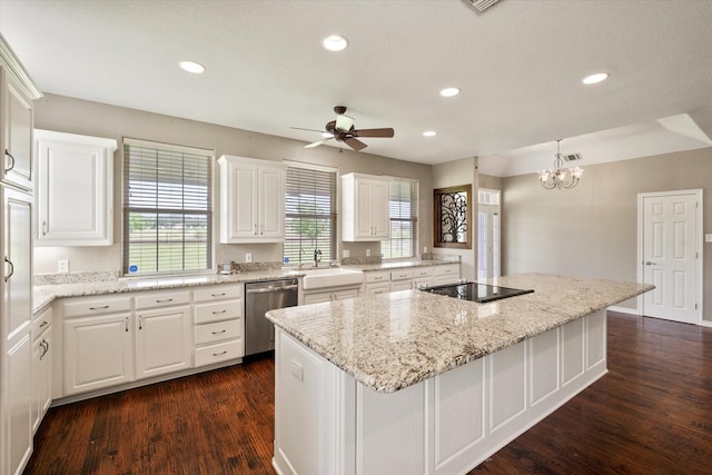 kitchen featuring a center island, dishwasher, a sink, white cabinetry, and black electric stovetop