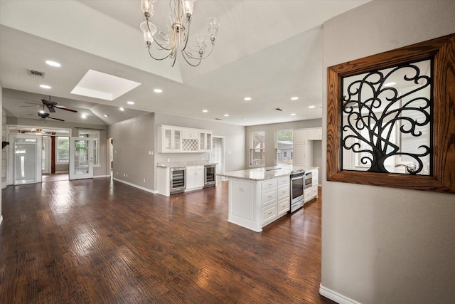 kitchen with white cabinetry, baseboards, dark wood-style floors, wine cooler, and recessed lighting