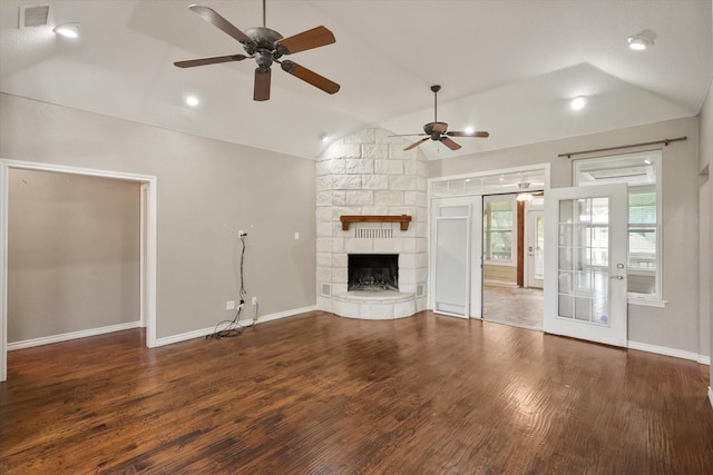unfurnished living room featuring a ceiling fan, wood finished floors, visible vents, and vaulted ceiling