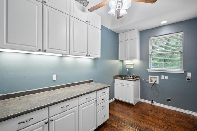 clothes washing area with a sink, cabinet space, dark wood-type flooring, a ceiling fan, and washer hookup