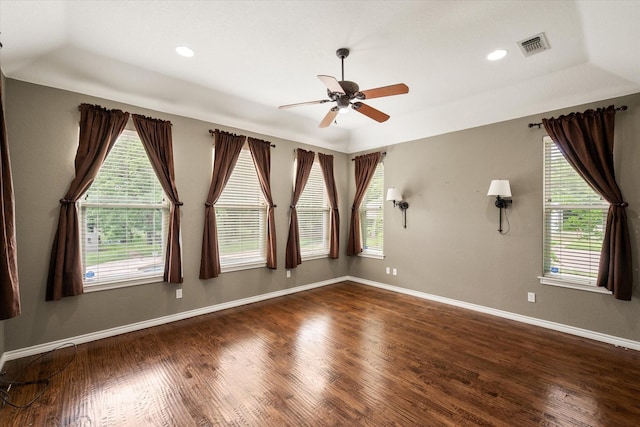unfurnished room featuring baseboards, a ceiling fan, plenty of natural light, and wood finished floors