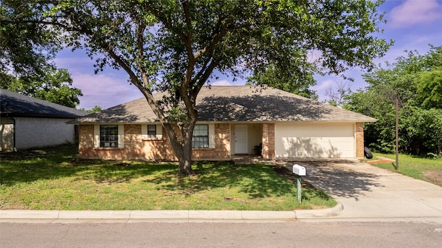 single story home featuring an attached garage, brick siding, driveway, and a front lawn