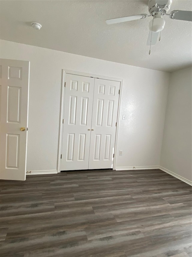 4406 Bobbie Ann Dr, Granbury, TX 76049 - unfurnished bedroom with a closet, baseboards, a ceiling fan, and dark wood-style floors