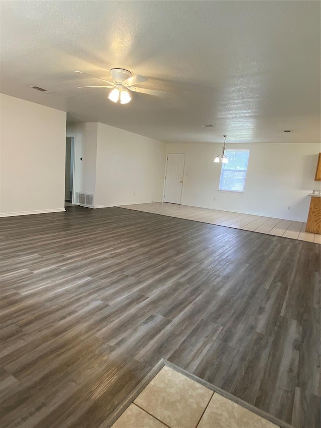 4406 Bobbie Ann Dr, Granbury, TX 76049 - unfurnished living room with a textured ceiling, a ceiling fan, visible vents, and wood finished floors