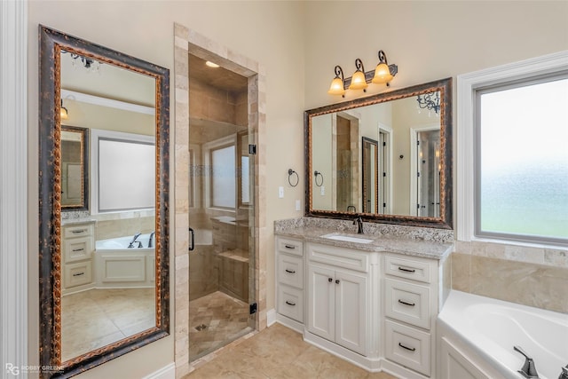 full bath featuring a bath, vanity, and a shower stall