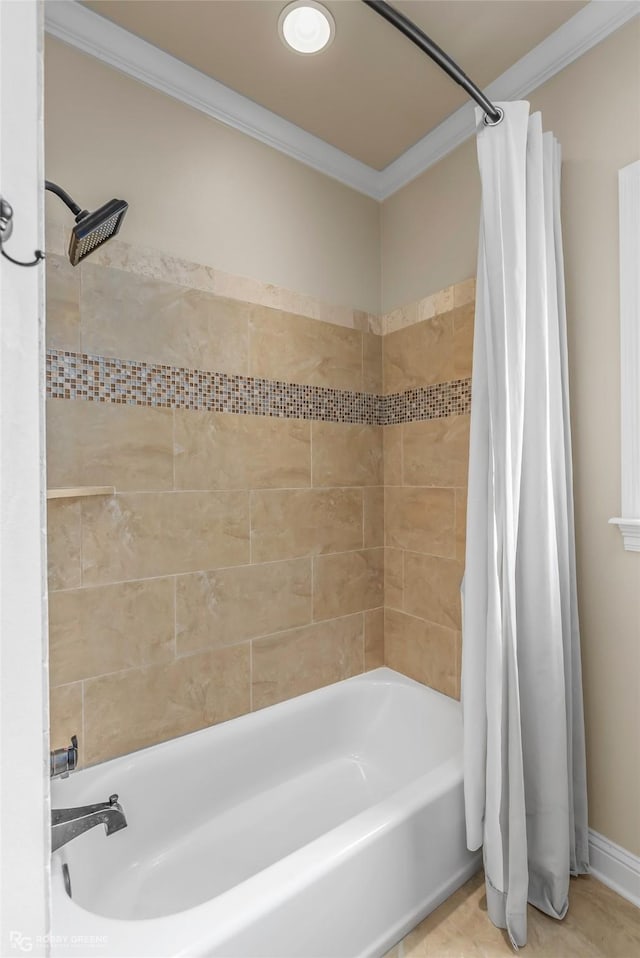 bathroom with crown molding, shower / tub combo with curtain, and baseboards