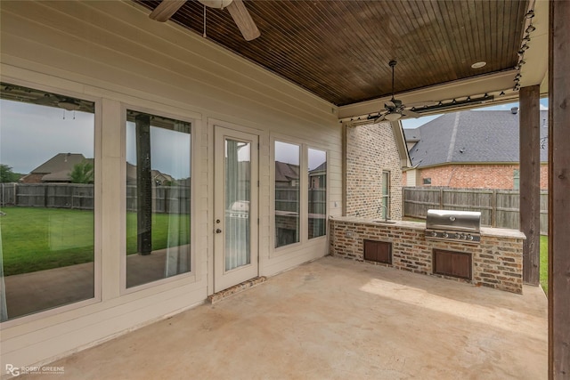 view of patio / terrace with fence, an outdoor kitchen, and ceiling fan