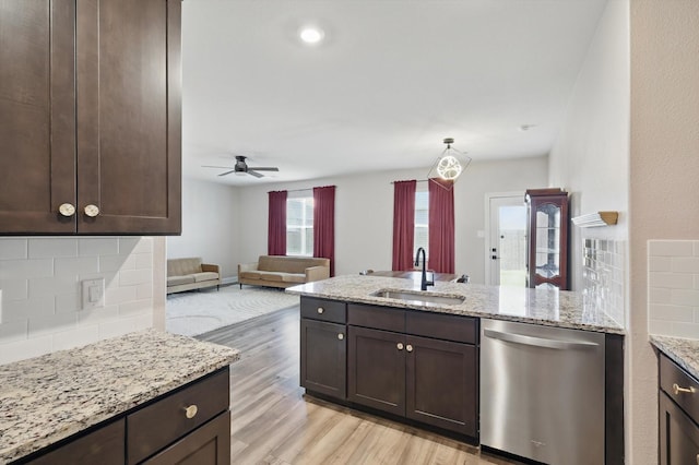 7616 Duck Bay Rd, Fort Worth, TX 76120 - kitchen featuring stainless steel dishwasher, a sink, dark brown cabinetry, and backsplash