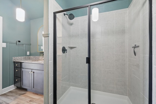7616 Duck Bay Rd, Fort Worth, TX 76120 - bathroom featuring a stall shower, wood finished floors, and vanity