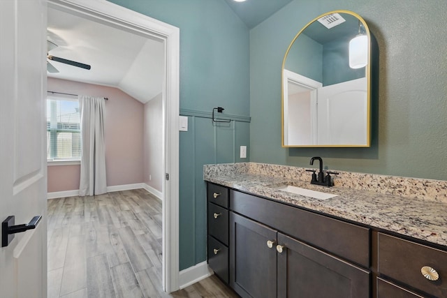 7616 Duck Bay Rd, Fort Worth, TX 76120 - bathroom with vaulted ceiling, wood finished floors, a ceiling fan, vanity, and baseboards