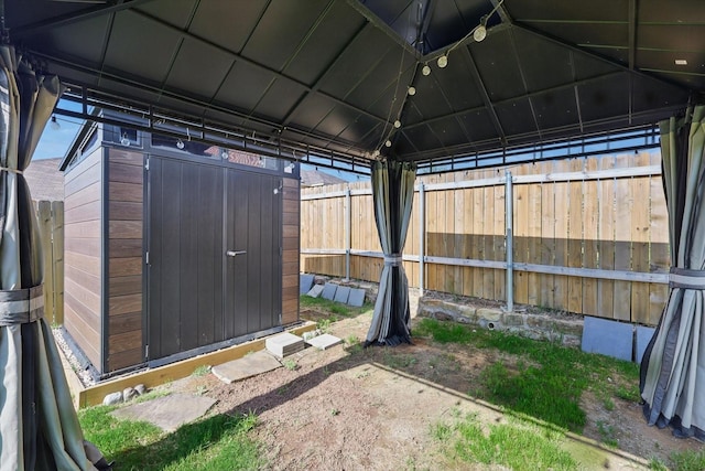 7616 Duck Bay Rd, Fort Worth, TX 76120 - view of shed featuring a fenced backyard and a gazebo