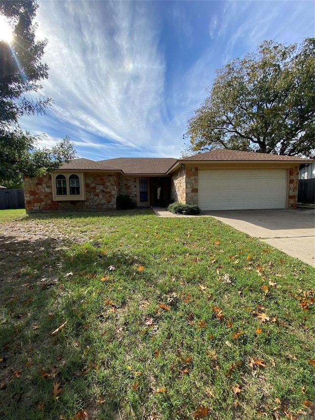 1124 Dove Hollow Rd, Granbury, TX 76048 - ranch-style home with concrete driveway, stone siding, an attached garage, and a front yard