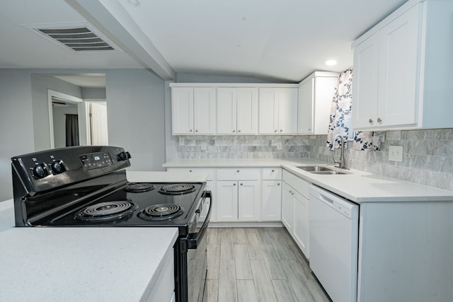 309 James St, Terrell, TX 75160 - kitchen with black electric range, dishwasher, a sink, tasteful backsplash, and vaulted ceiling