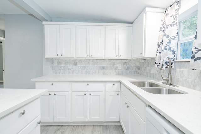 309 James St, Terrell, TX 75160 - kitchen featuring a sink, light countertops, white dishwasher, and decorative backsplash